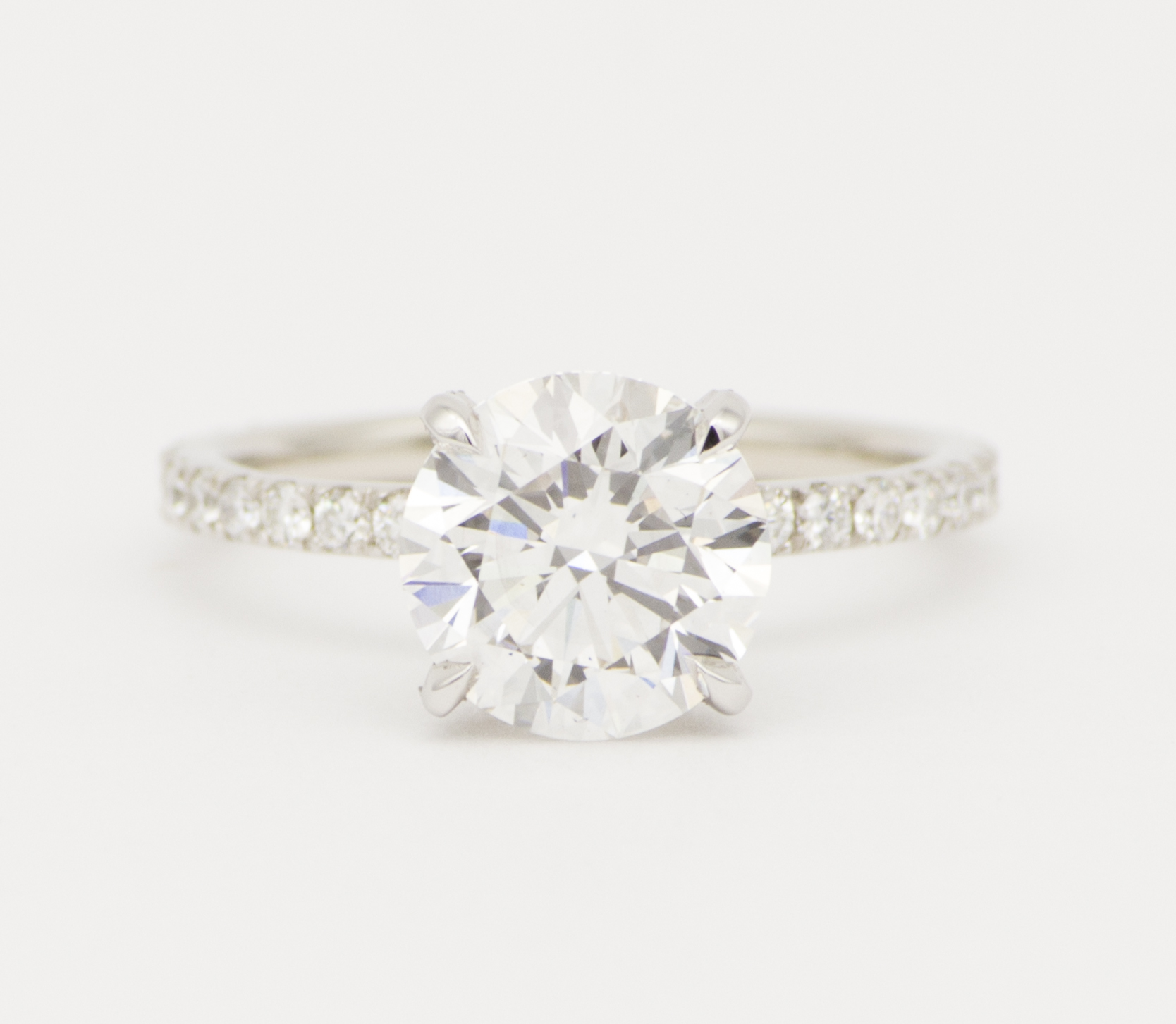 engagement ring with round diamond and accented shank